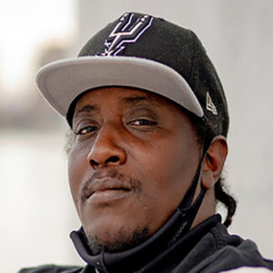 Man wearing black baseball hat