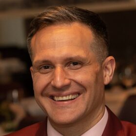 Smiling man with short brown hair